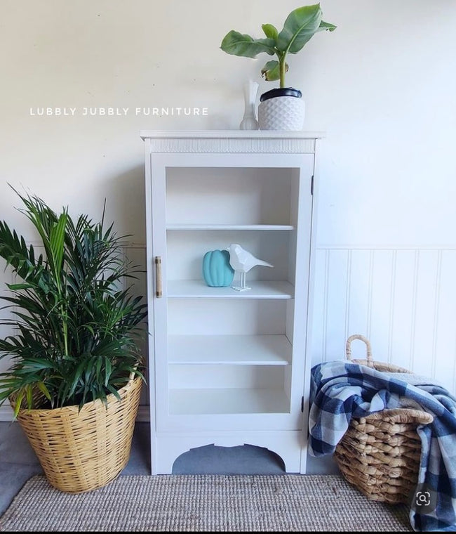 White painted linen cabinet with woven baskets