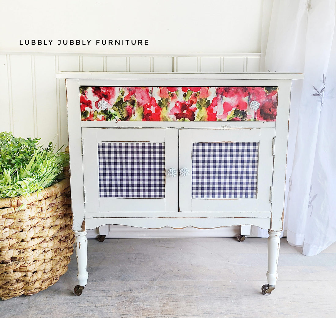 farmhouse cabinet with gingham and floral decorative front crinoline white casters wicker basket with plant