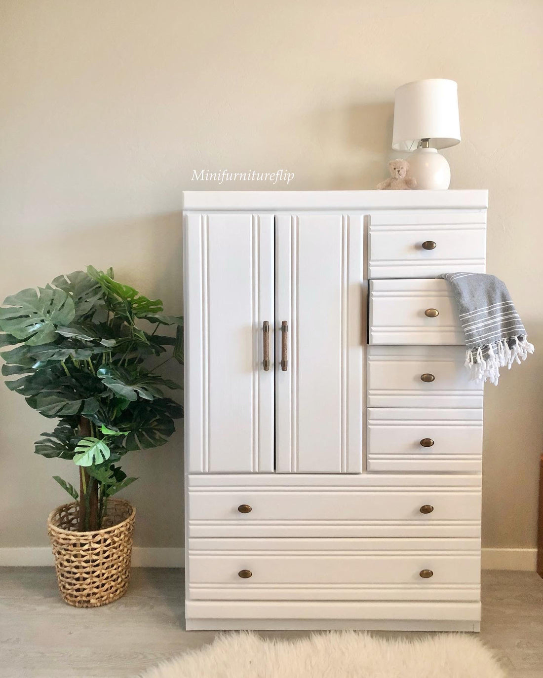 White painted wardrobe with indoor tropical potted plant