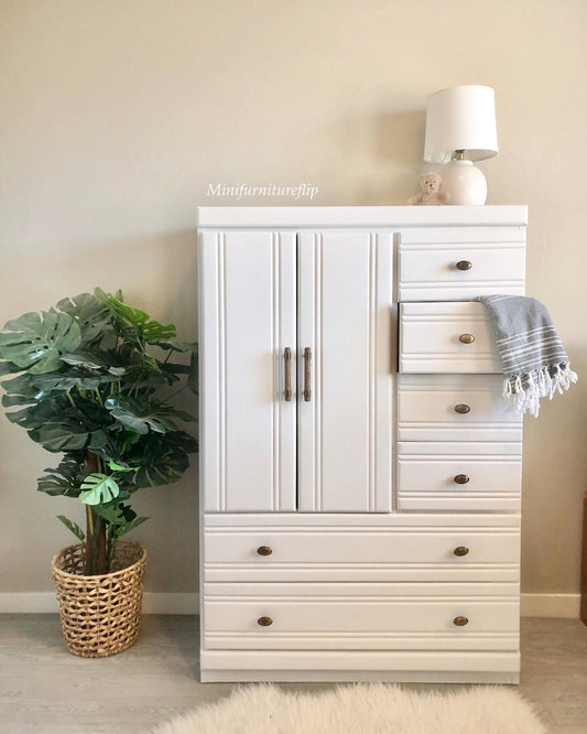 White painted wardrobe with indoor tropical potted plant