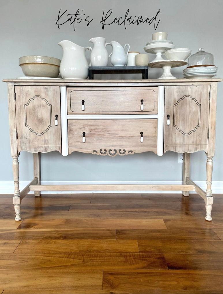 White washed wood buffet server with white china cake stands mixing bowls