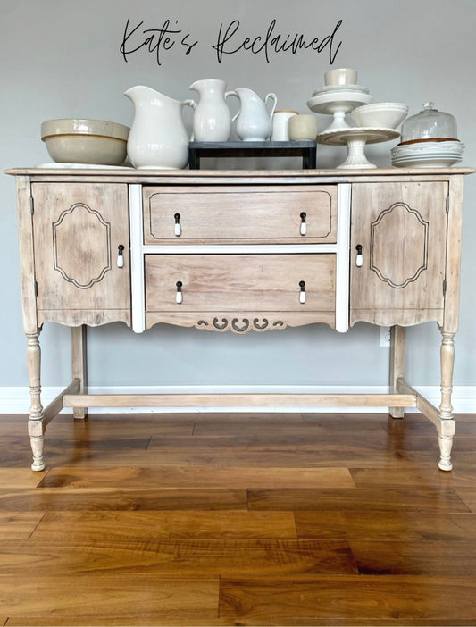 White washed wood buffet server with white china cake stands mixing bowls