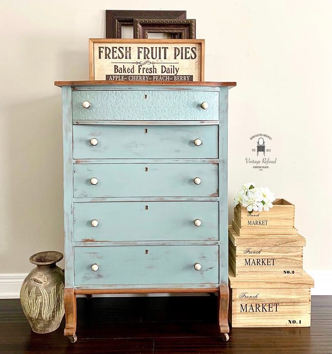 Distressed blue farmhouse painted dresser with textured wallpaper drawer