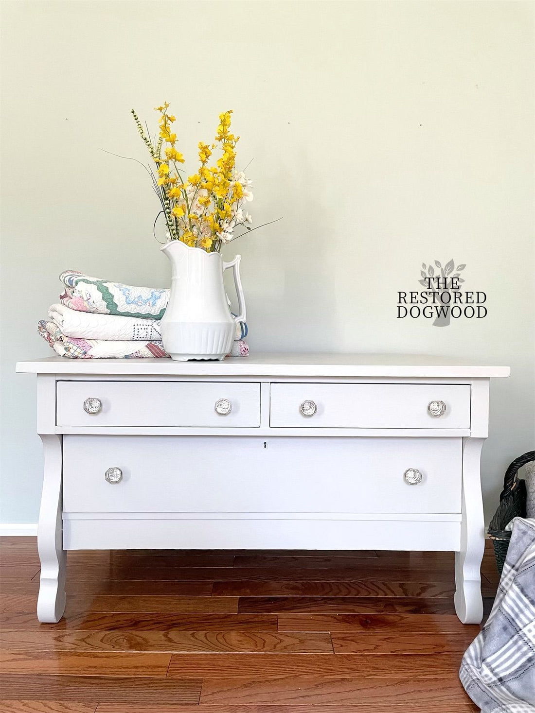 Light grey painted farmhouse style dresser with milk jug and yellow flowers