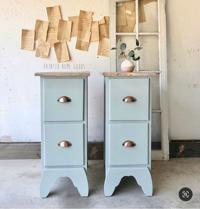 Matching dusty blue nightstands with brass metallic cup pulls