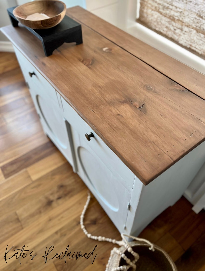 Grey cabinet with dark stained wood top