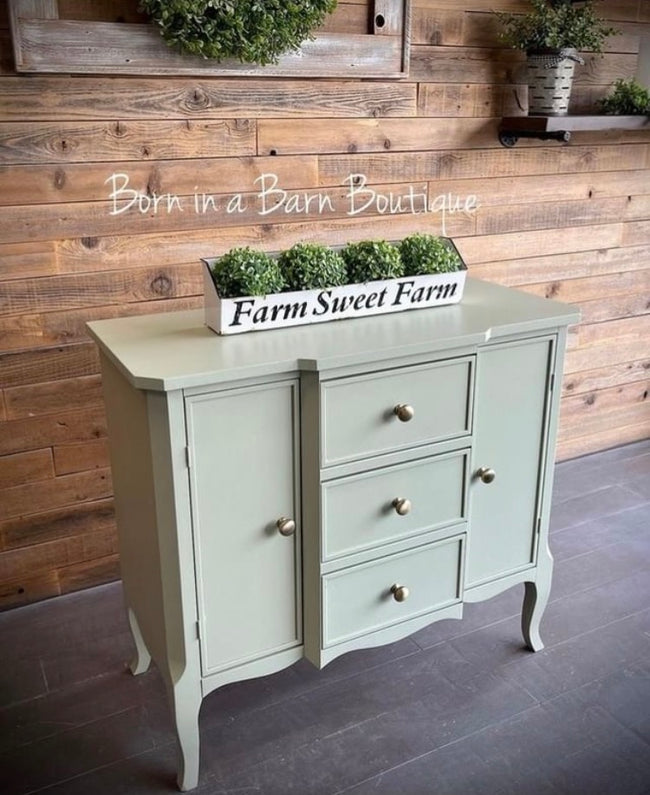 Sage green cabinet with rustic barn wood planked wall treatment