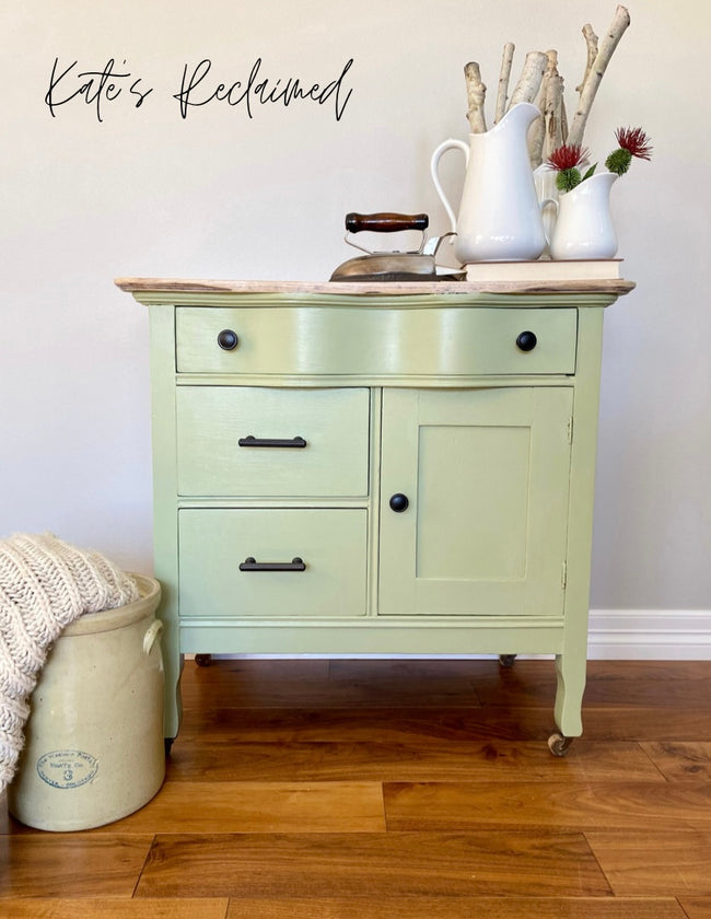 Serpentine antique washstand painted sage green with casters