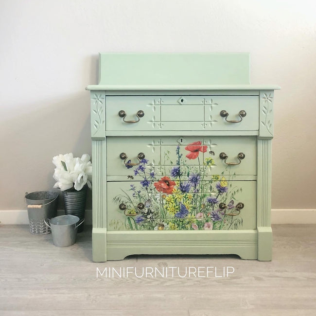 Sage green dresser with floral decals and carvings and galvanized buckets