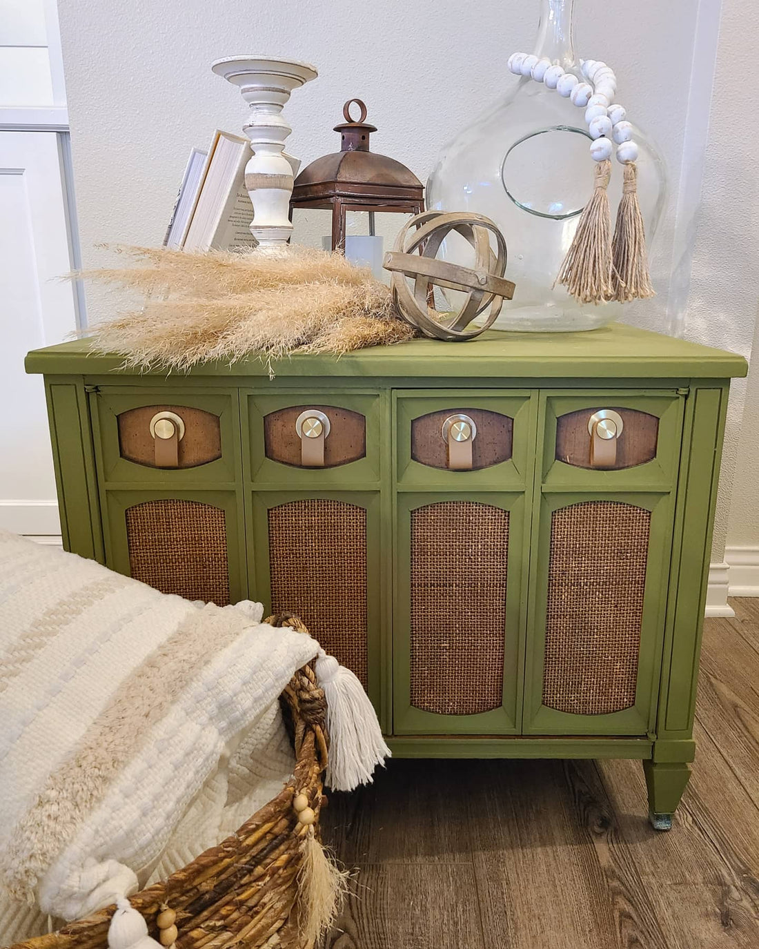 Green painted record cabinet with leather pulls and burlap inserts