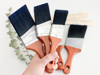 3 sizes of Country Chic Paint Short Handle Brushes held in hand