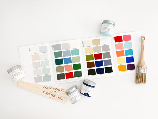 country chic paint color chart featuring 50 color swatches flatlay with paint jars, brushes, and stir sticks