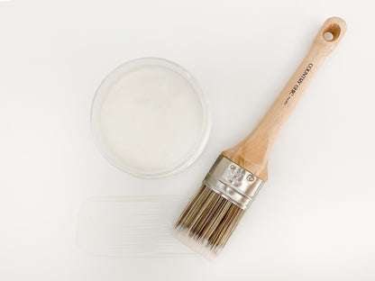 Flatlay jar of clear furniture glaze with brush stroke showing color