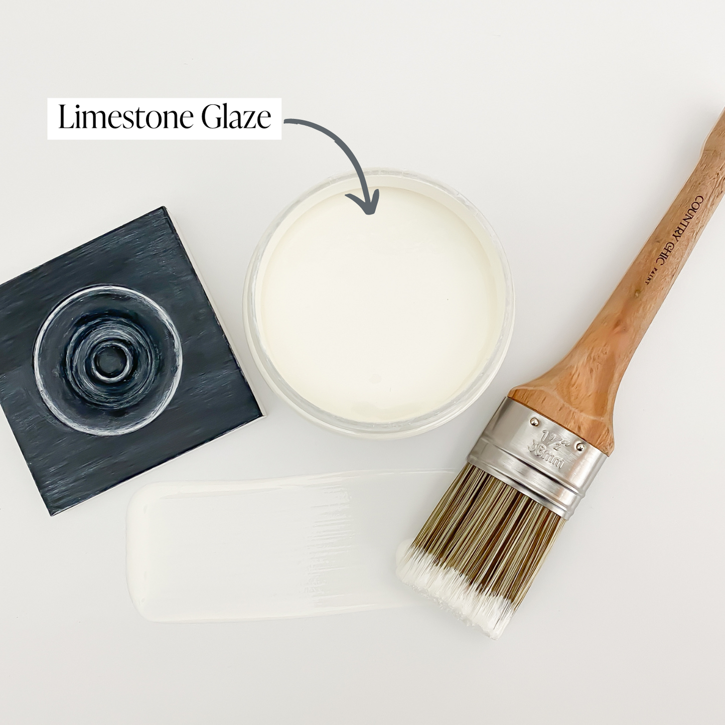 Flatlay jar of limestone furniture glaze with brush stroke showing color and sample board