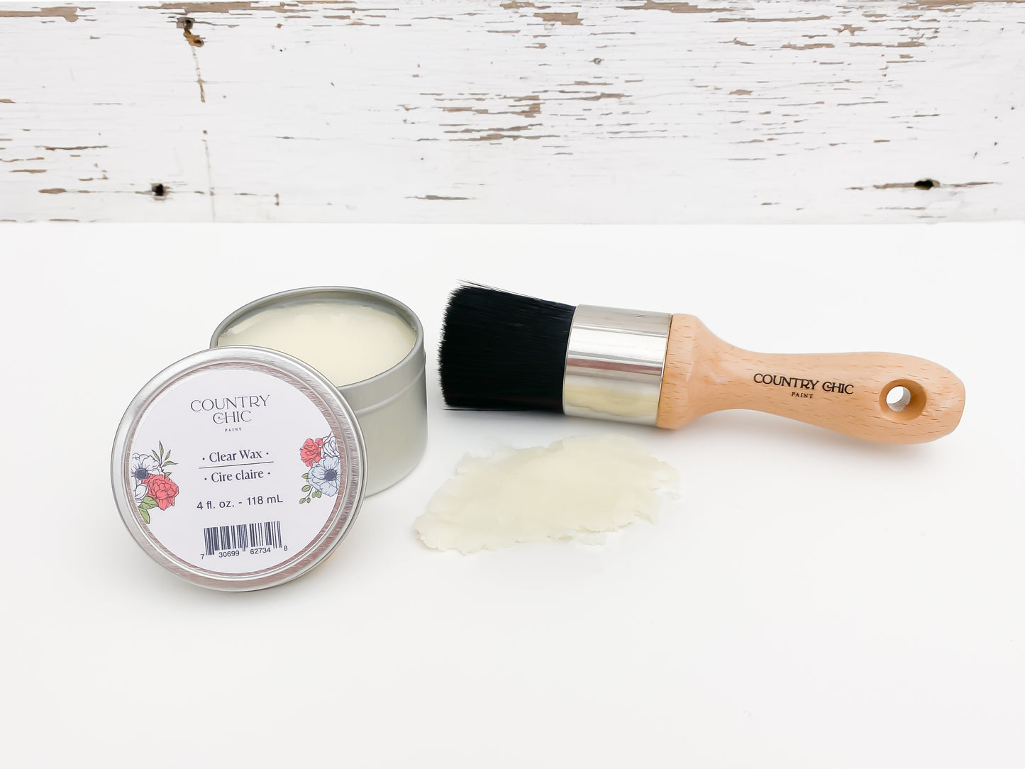 Flatlay of natural clear wax from country chic paint next to wax brush and smear of wax