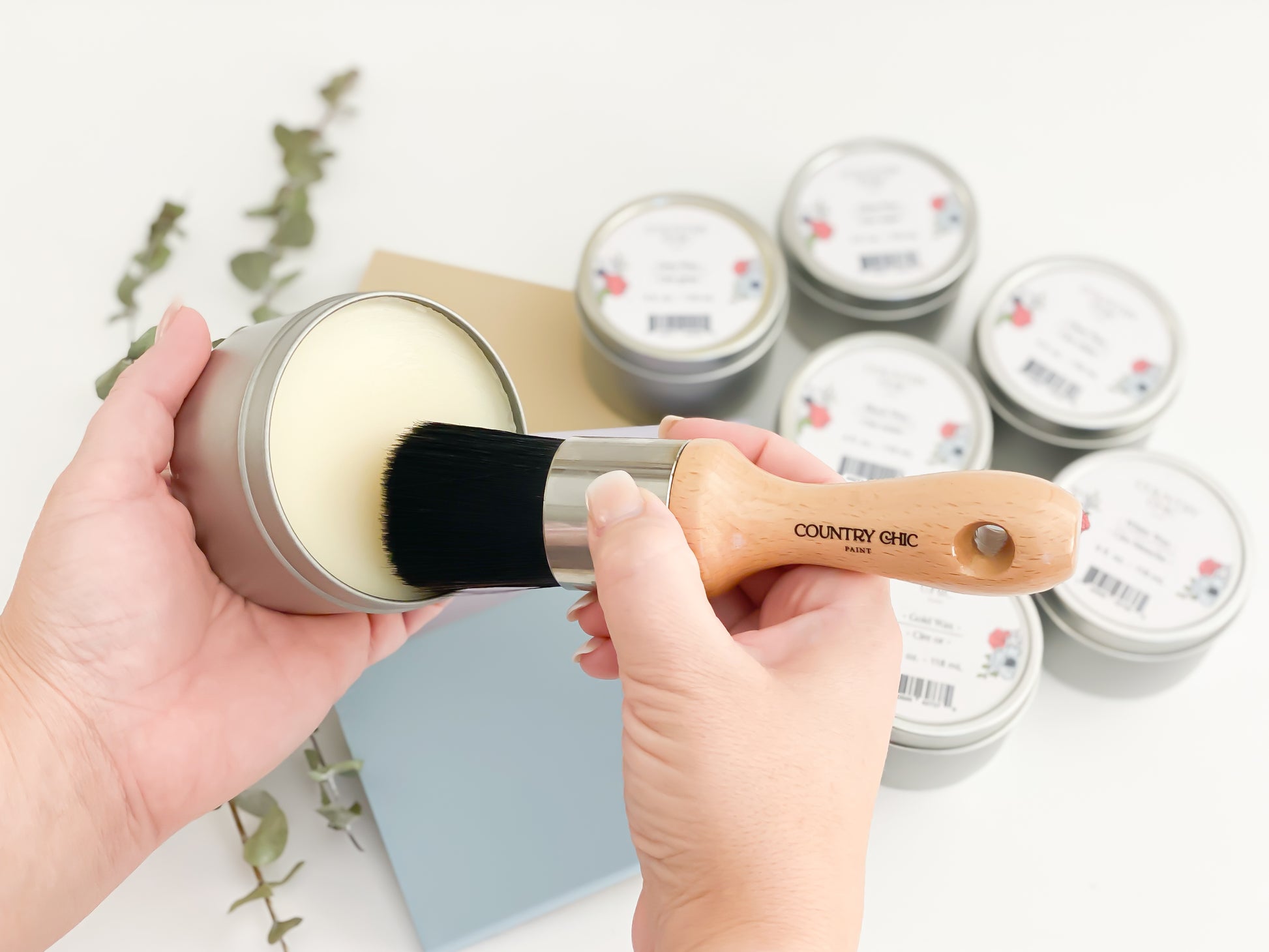 A Country Chic Paint Wax Brush swirling in clear wax jar